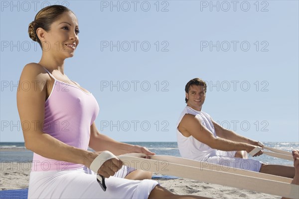 Hispanic couple practicing yoga