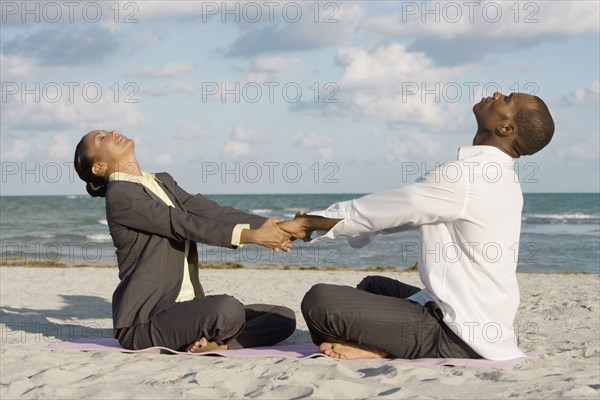 Multi-ethnic businesspeople stretching