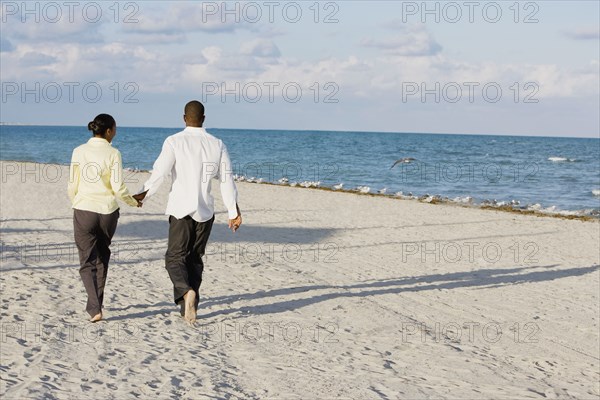 Multi-ethnic couple holding hands