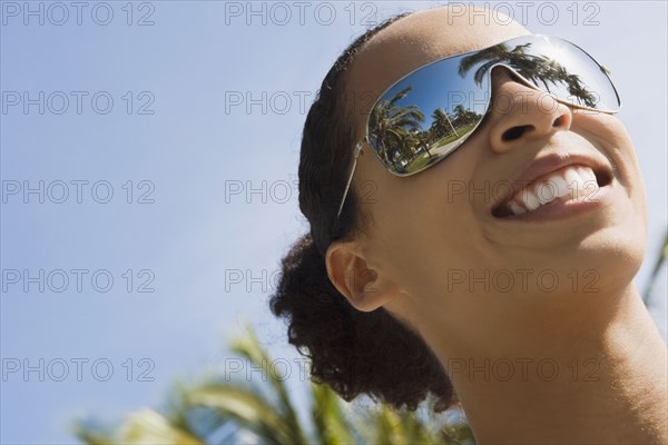 African woman wearing mirrored sunglasses