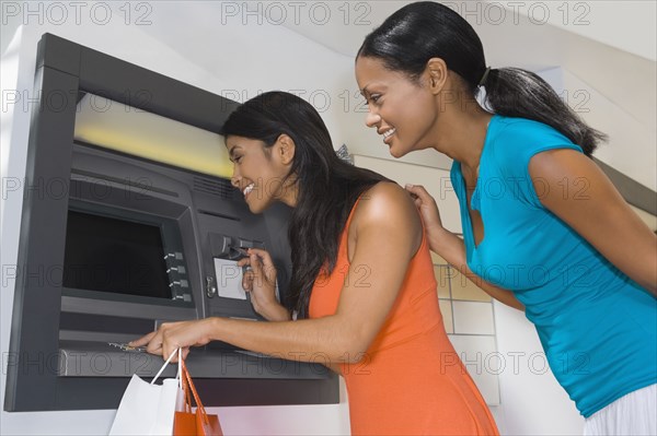 Hispanic women using atm