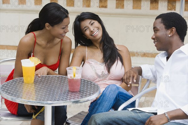 Multi-ethnic friends at outdoor cafe