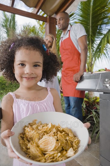 African girl holding bowl of cereal