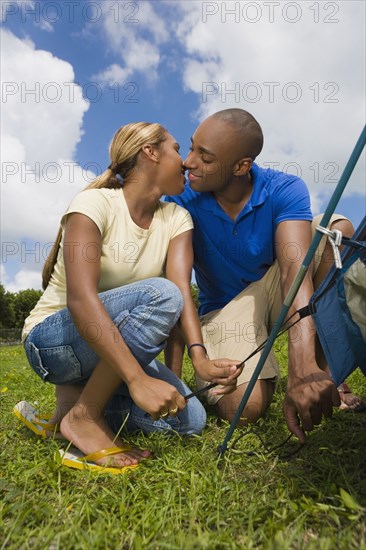 African couple setting up tent