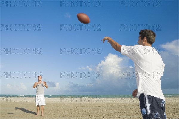 Multi-ethnic men playing catch