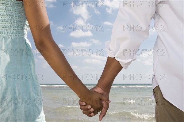 Multi-ethnic couple holding hands