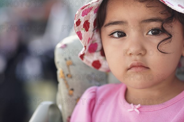 Hispanic baby girl wearing hat