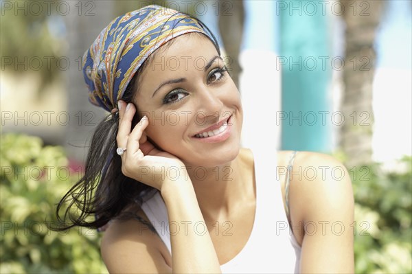 Hispanic woman wearing scarf on head