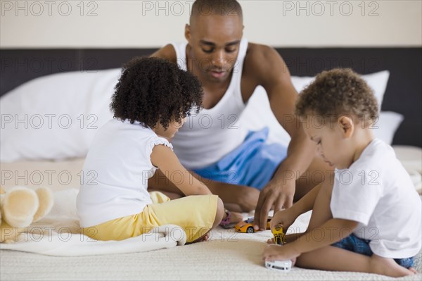 African father playing with children