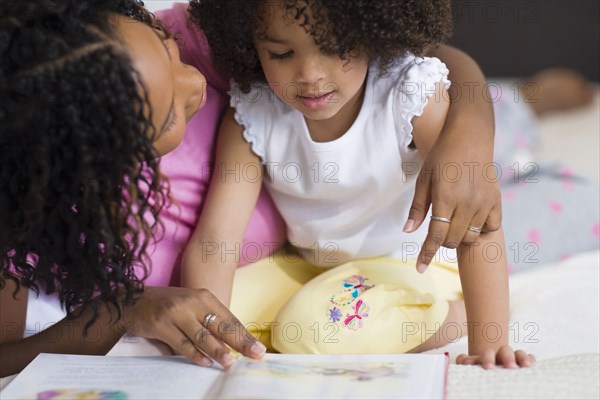 African mother reading to daughter