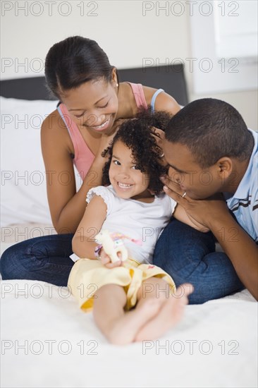 African parents smiling at daughter