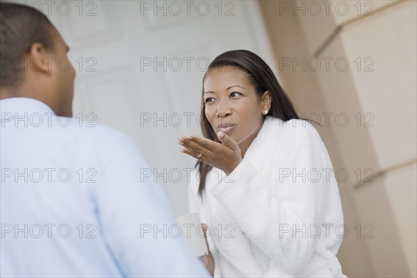 African woman blowing kiss to husband
