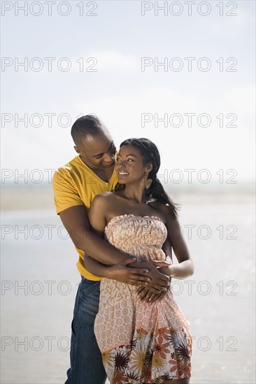 Multi-ethnic couple hugging at beach