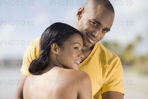 Multi-ethnic couple hugging