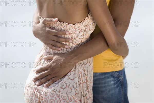 Multi-ethnic couple hugging