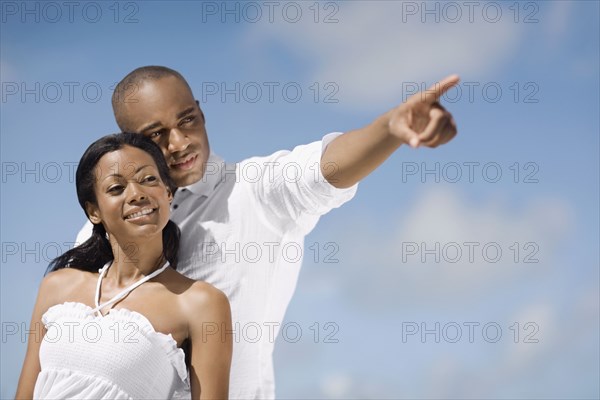 African man pointing for girlfriend