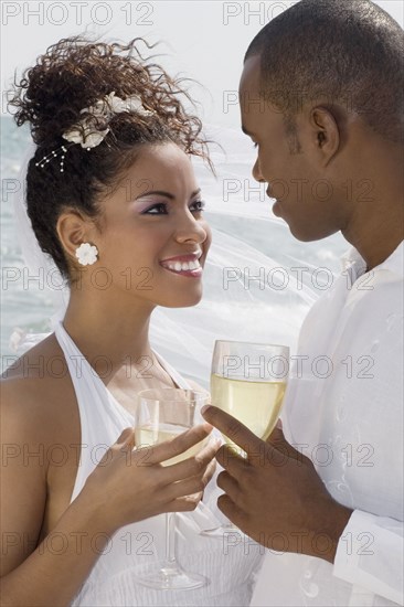 Multi-ethnic bride and groom smiling at each other