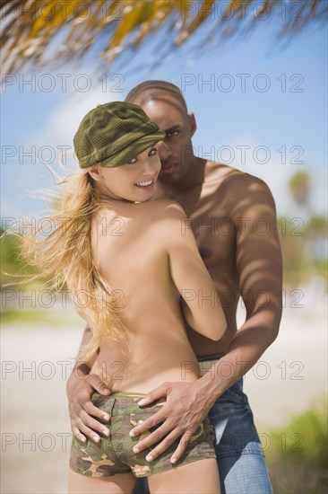 Multi-ethnic couple hugging