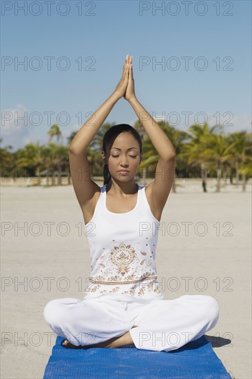 Hispanic woman practicing yoga