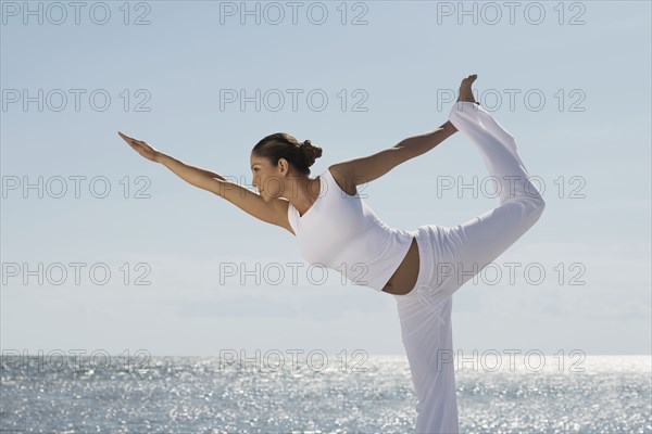 Hispanic woman practicing yoga