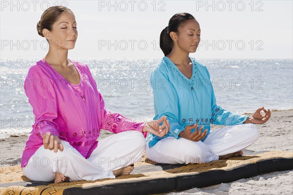 Multi-ethnic women meditating