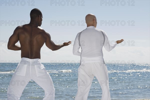 Multi-ethnic men practicing yoga