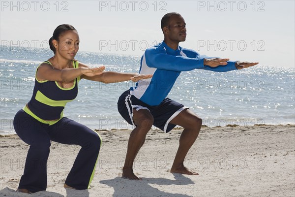 Multi-ethnic couple practicing yoga