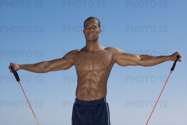 African man stretching with exercise band