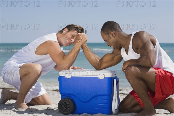 Multi-ethnic men arm wrestling