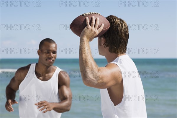 Multi-ethnic men playing football