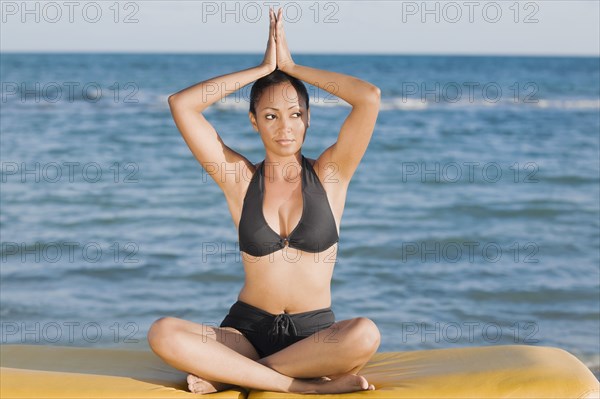 Hispanic woman practicing yoga