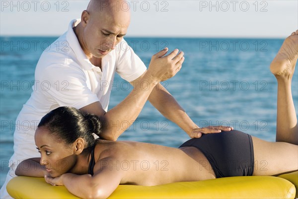 Hispanic woman receiving massage