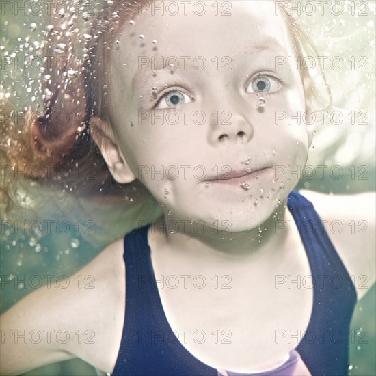 Caucasian girl swimming under water