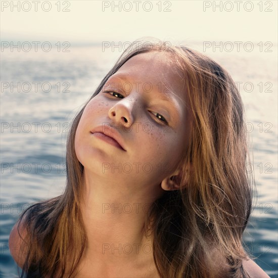 Caucasian girl standing on beach