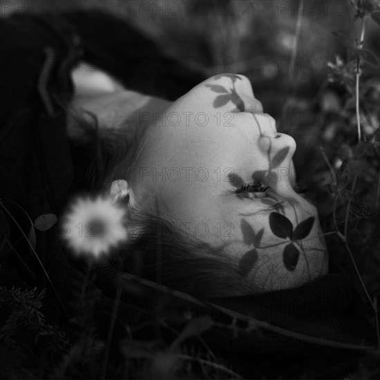 Caucasian girl laying in grass