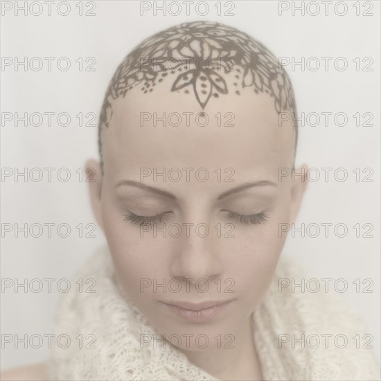 Caucasian woman with bald tattooed head