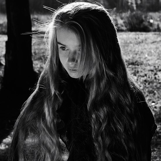 Caucasian girl walking in forest