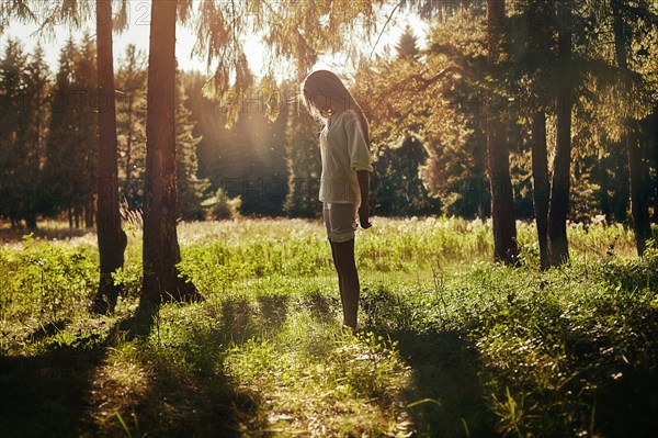 Caucasian girl walking in forest