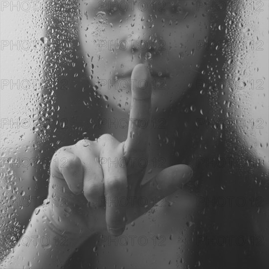 Caucasian woman pressing wet glass