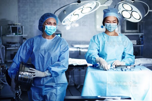 Caucasian surgeons preparing operating room