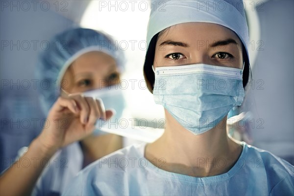 Caucasian surgeon wearing mask in operating room