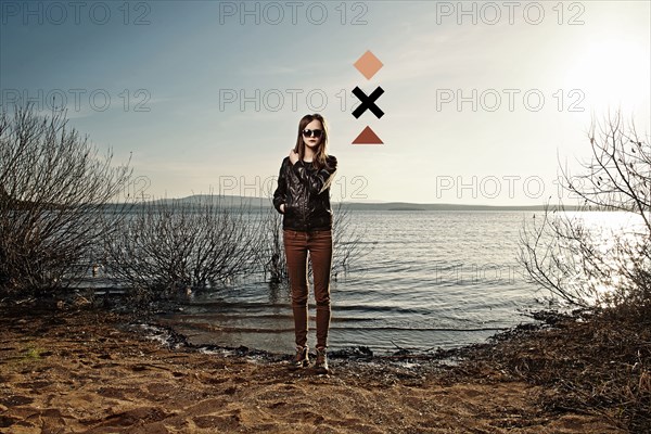 Caucasian woman standing on sandy beach