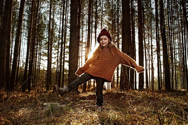 Caucasian girl standing in forest