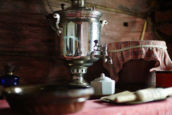 Tea dispenser and plates on table