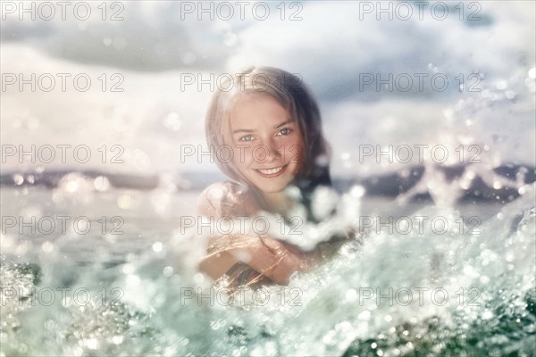 Caucasian girl splashing in lake