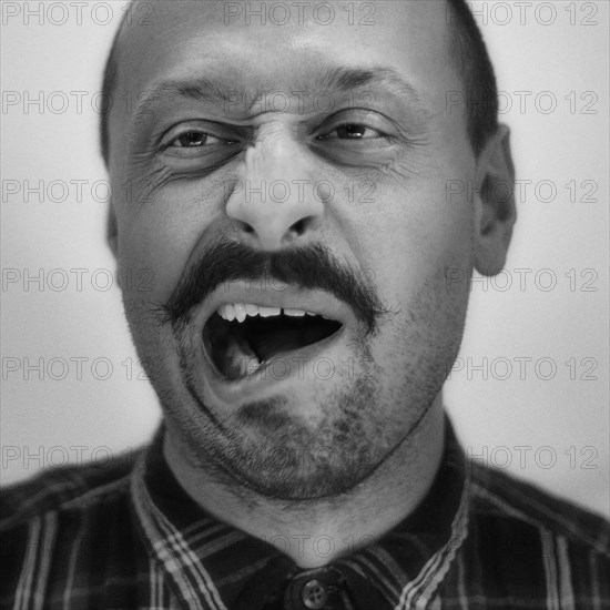 Close up of Caucasian man grimacing