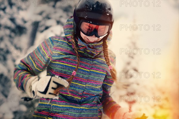 Caucasian girl wearing helmet and goggles in winter