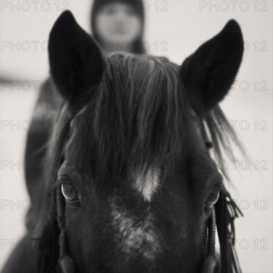 Caucasian girl riding horse outdoors