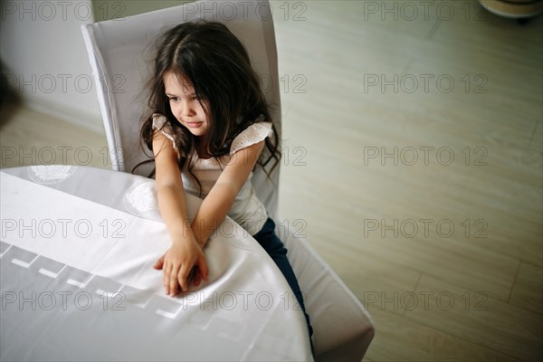 Caucasian girl sitting at table