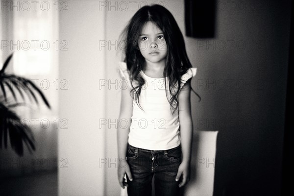 Caucasian girl standing on chair